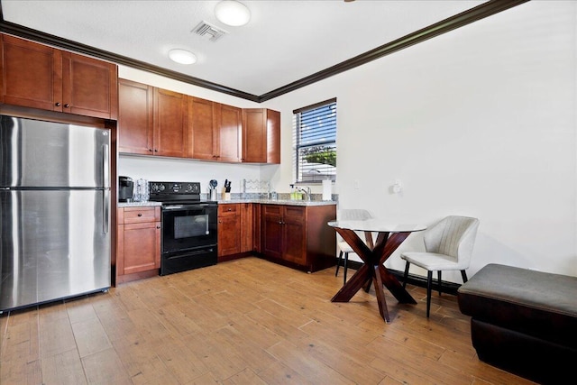 kitchen featuring light hardwood / wood-style flooring, black electric range, stainless steel fridge, ornamental molding, and light stone counters