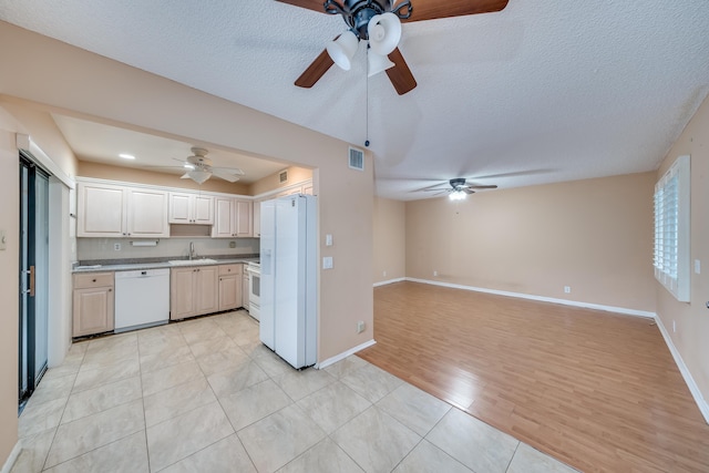 kitchen with a textured ceiling, white appliances, sink, light hardwood / wood-style flooring, and white cabinets