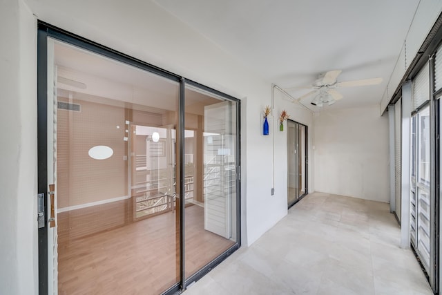 sunroom / solarium featuring ceiling fan