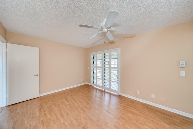 unfurnished room with ceiling fan, a textured ceiling, and light wood-type flooring