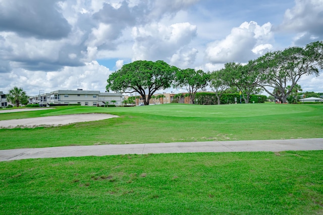 view of home's community with a yard