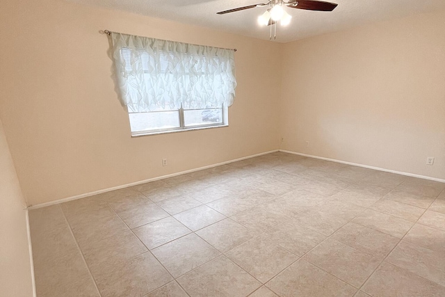 empty room featuring ceiling fan and light tile patterned flooring