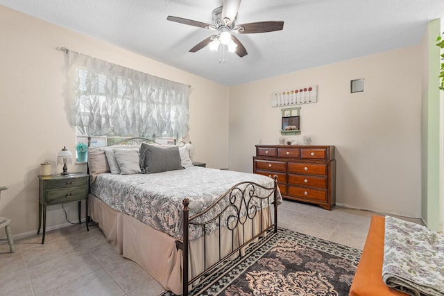 tiled bedroom featuring a textured ceiling and ceiling fan