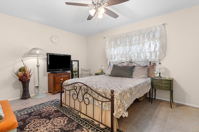 tiled bedroom featuring ceiling fan