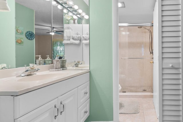 bathroom featuring tile patterned flooring, vanity, ceiling fan, and a shower with shower door