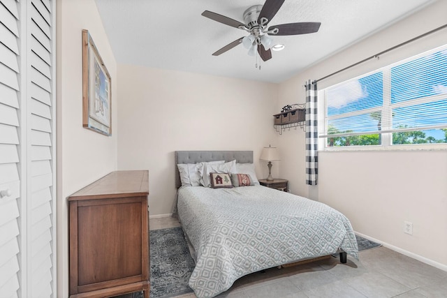 tiled bedroom with ceiling fan