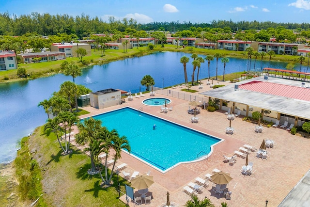 view of pool with a patio area and a water view