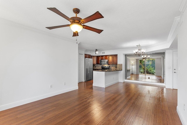 unfurnished living room with ceiling fan with notable chandelier, a textured ceiling, dark hardwood / wood-style flooring, and ornamental molding