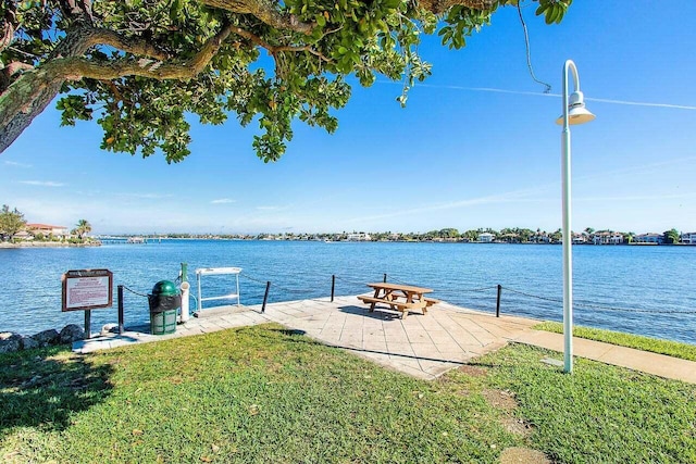 dock area with a water view and a yard