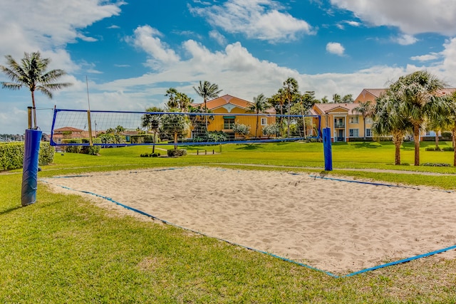 view of home's community featuring a lawn and volleyball court