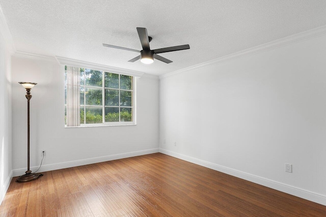 spare room featuring hardwood / wood-style floors, ceiling fan, a textured ceiling, and ornamental molding