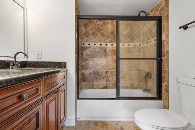 full bathroom with enclosed tub / shower combo, a textured ceiling, toilet, and vanity