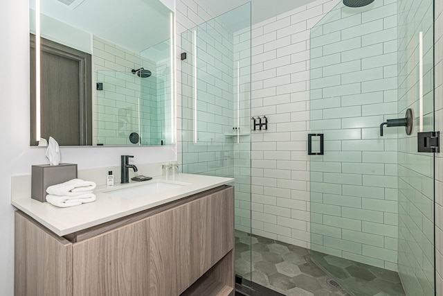 bathroom featuring vanity and a shower with shower door