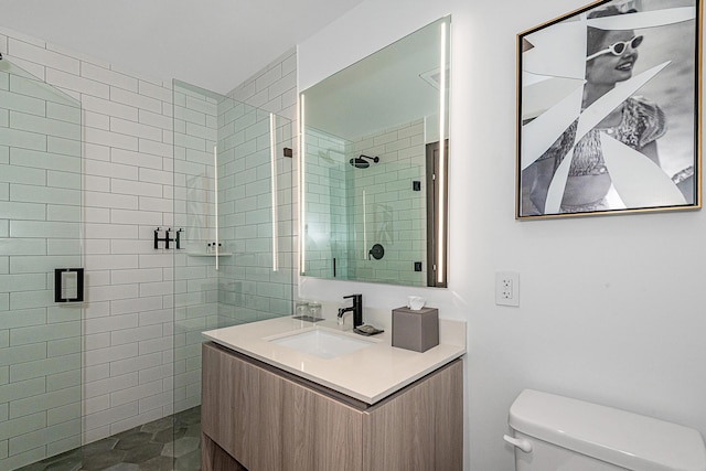 bathroom featuring vanity, toilet, and an enclosed shower