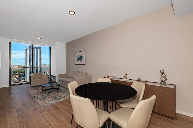 dining room with floor to ceiling windows and wood-type flooring