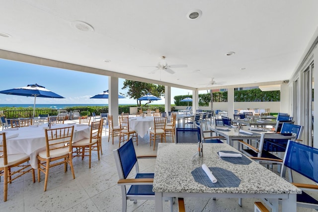 view of patio / terrace with ceiling fan and a water view