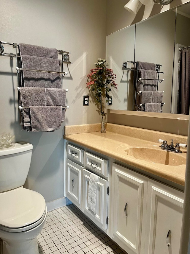 bathroom featuring vanity, toilet, and tile patterned floors