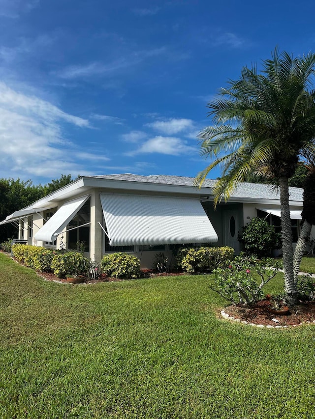 view of side of property with a yard