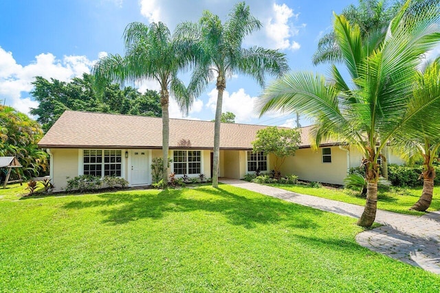 ranch-style home with a front yard