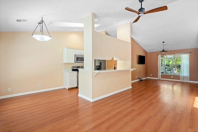 kitchen with light wood-type flooring, white cabinets, ceiling fan, appliances with stainless steel finishes, and high vaulted ceiling