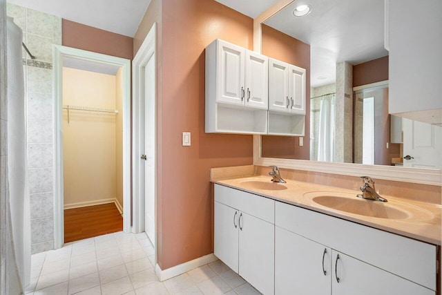 bathroom with dual vanity and tile patterned flooring