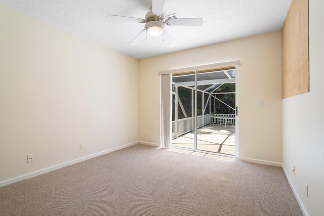 carpeted empty room featuring a textured ceiling and ceiling fan