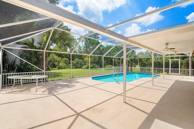 view of pool featuring a lanai, a patio area, and ceiling fan