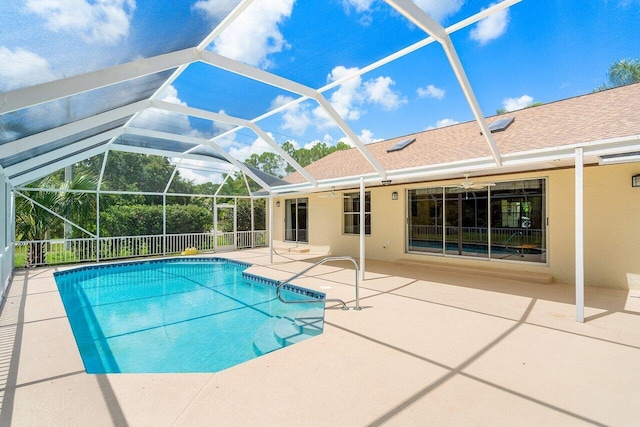 view of swimming pool with a patio, a lanai, and ceiling fan