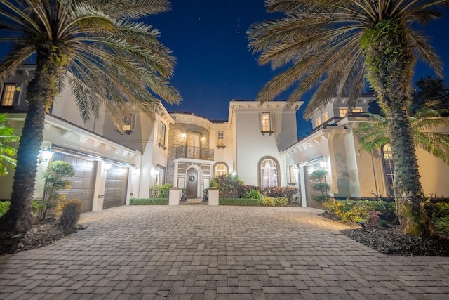 mediterranean / spanish house with a balcony and a garage