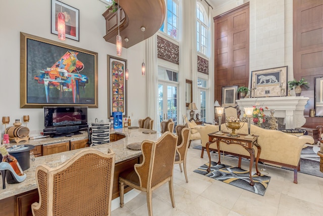 interior space featuring a fireplace and a high ceiling