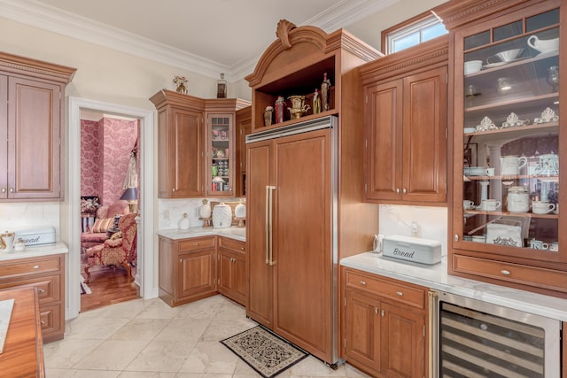 kitchen featuring wine cooler, backsplash, ornamental molding, and paneled fridge