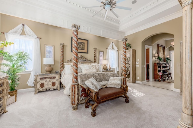 carpeted bedroom featuring crown molding, ceiling fan, and a tray ceiling