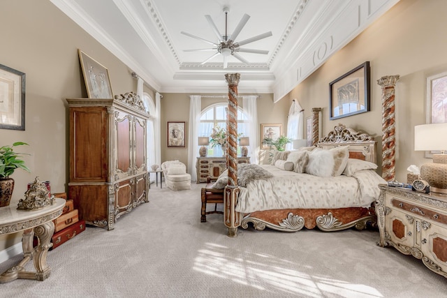 carpeted bedroom with ceiling fan, ornamental molding, and a raised ceiling