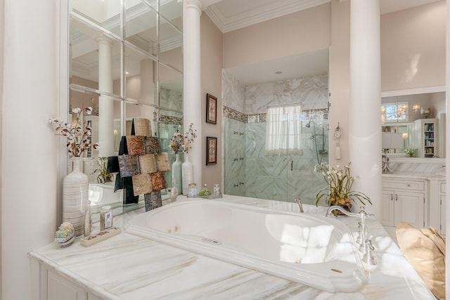 bathroom with ornamental molding, shower with separate bathtub, decorative columns, and vanity