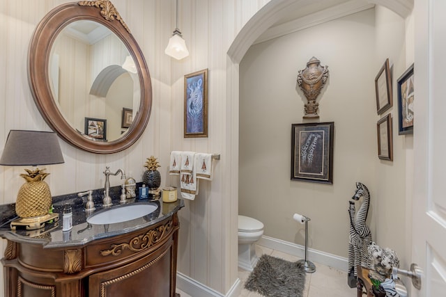 bathroom featuring tile patterned flooring, vanity, and toilet