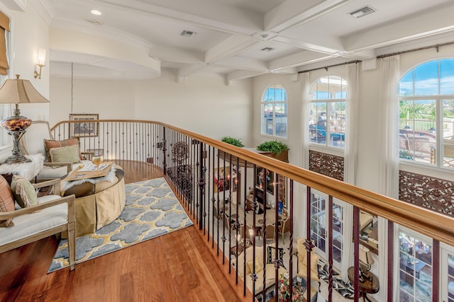 hallway featuring coffered ceiling, wood-type flooring, and beamed ceiling