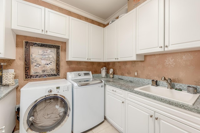 laundry area featuring sink, cabinets, washer and dryer, light tile patterned floors, and ornamental molding