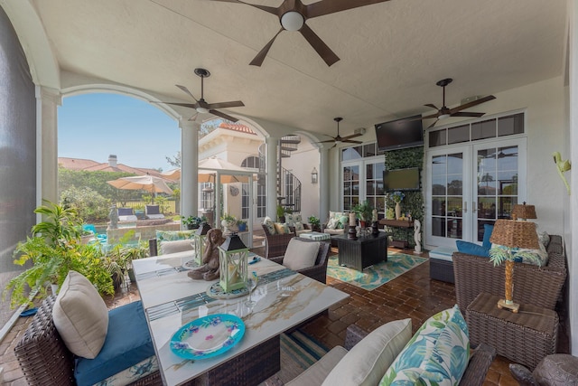 view of patio featuring an outdoor living space, ceiling fan, and french doors