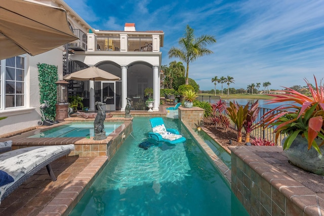 view of pool with an in ground hot tub and a patio area