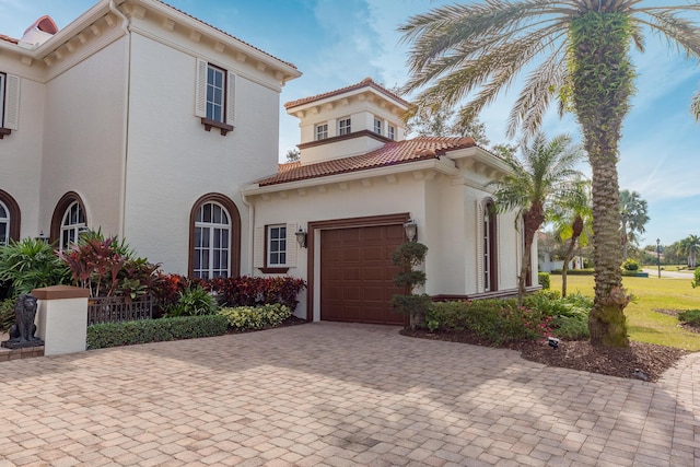 mediterranean / spanish-style home with a garage