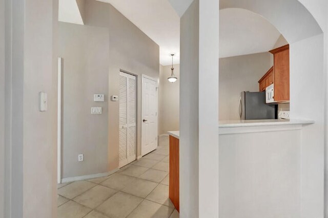 corridor with light tile flooring