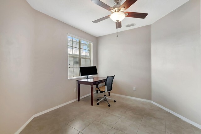 tiled home office featuring ceiling fan