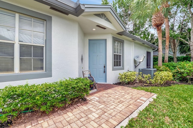 doorway to property featuring a patio and central AC