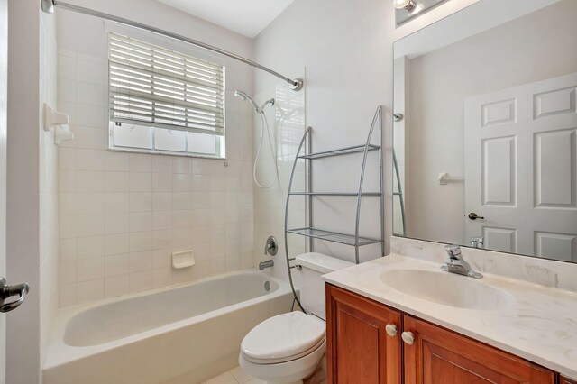 full bathroom featuring tiled shower / bath, toilet, and vanity