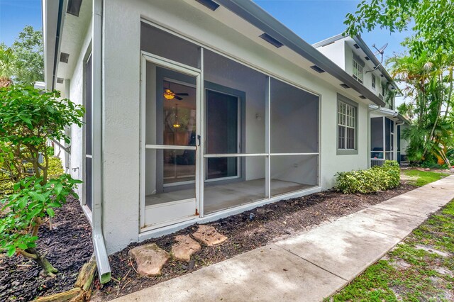 view of property exterior with a sunroom