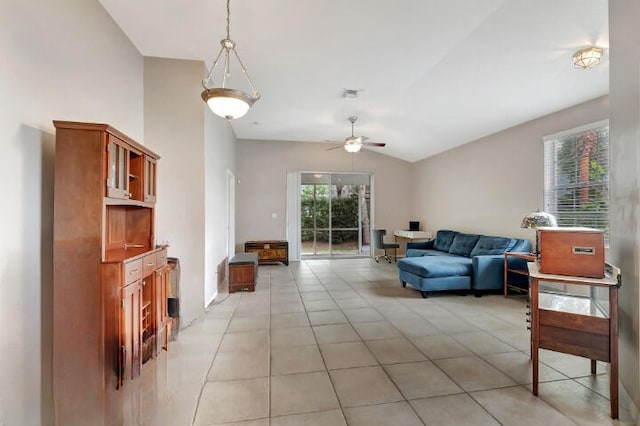 tiled living room with ceiling fan and vaulted ceiling