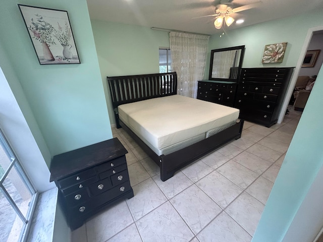 bedroom with light tile flooring, multiple windows, and ceiling fan