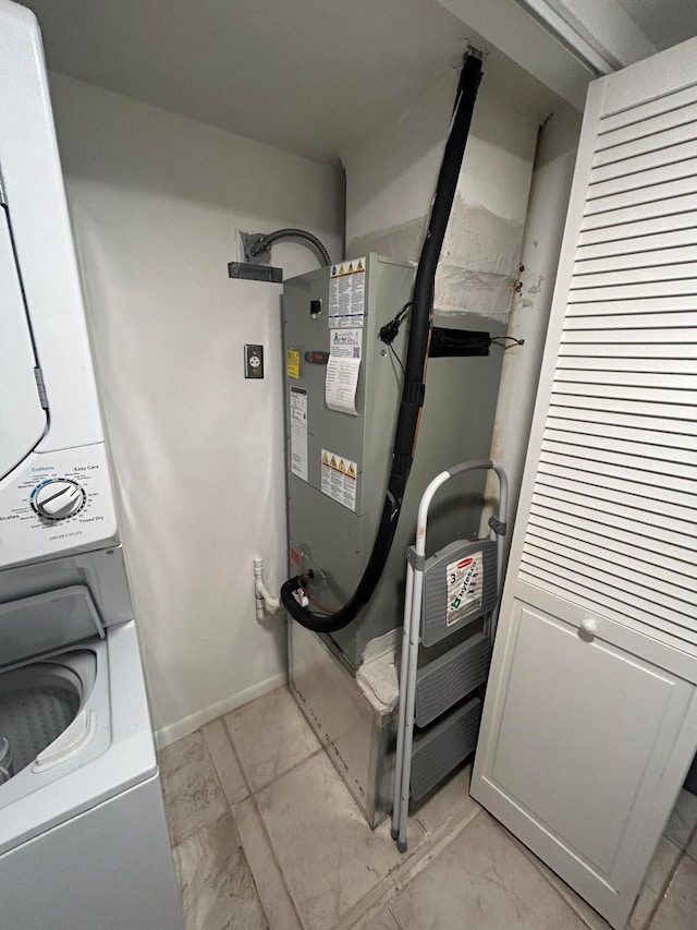 utility room featuring stacked washer and clothes dryer