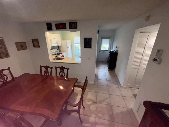 tiled dining area featuring sink