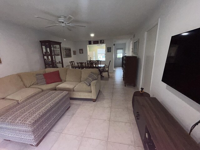 living room featuring tile flooring and ceiling fan